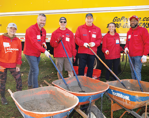 people posing with wheelbarrows