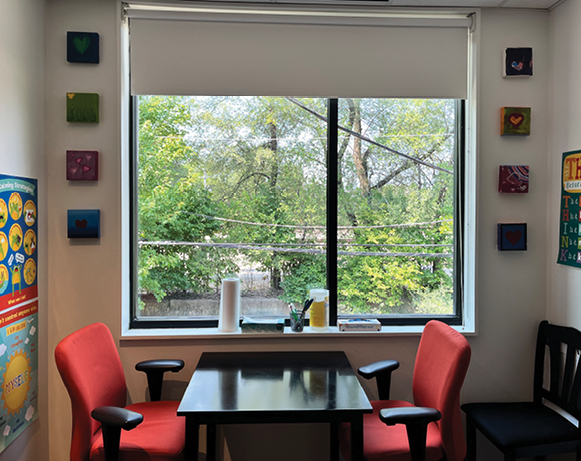 a table and chairs in front of a window