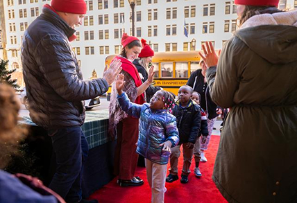 young children walking from school bus into performance venue