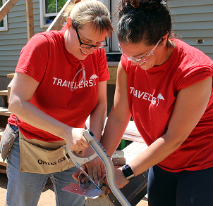 Travelers employees doing carpentry at construction site