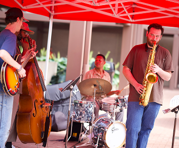 band playing under a tent outdoors