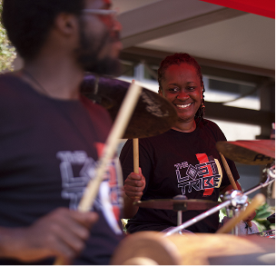 band playing under a tent outdoors