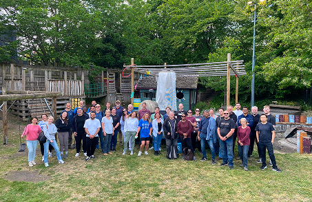 large group posing for the camera at a playground
