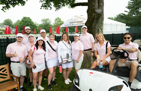 group posing for camera at Travelers Championship